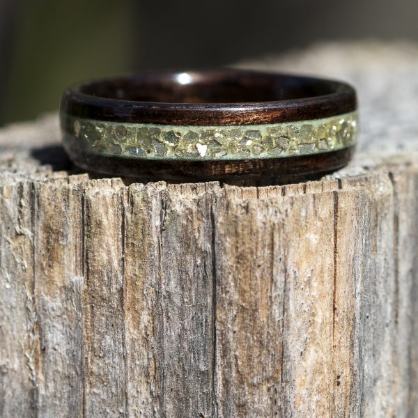 Ebony wooden ring with gold glass and green glow powder inlay