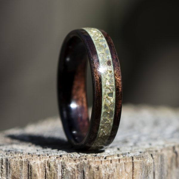 Ebony wooden ring with gold glass and green glow powder inlay