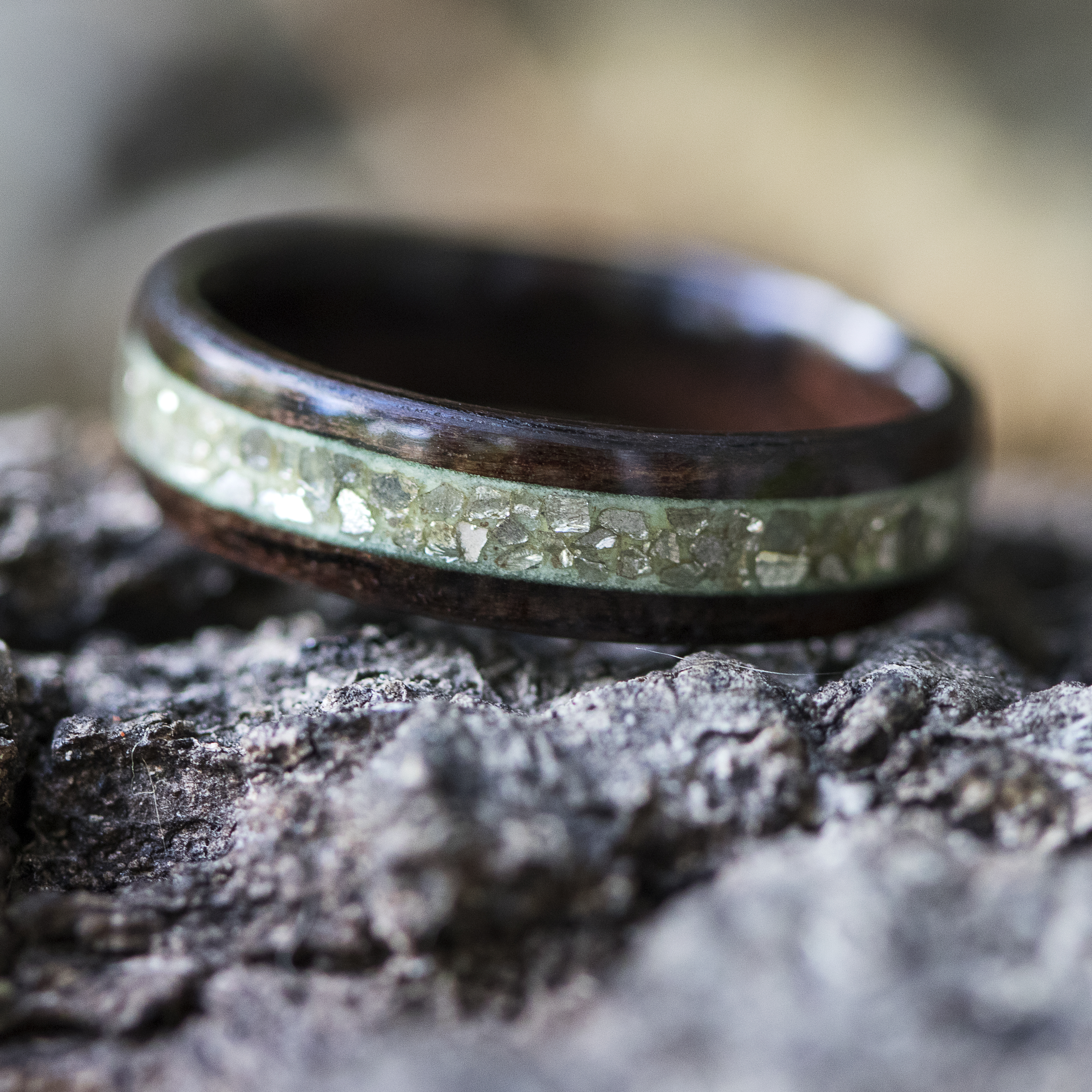 Hand crafted titanium ring with space themed glow powder inlay 
