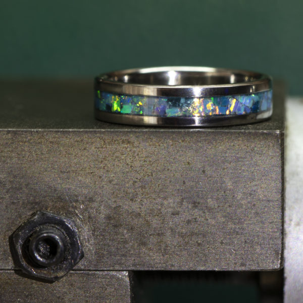 Titanium ring inlaid with turquoise colored opal